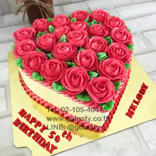 Red and white cream cake with rose decorations